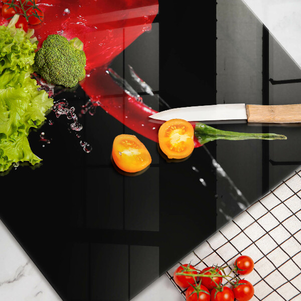 Tabla de cortar de vidrio Pimientos rojos en agua