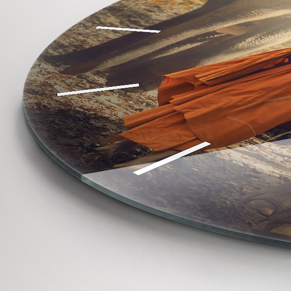 Reloj de pared redondo Monje guiando elefantes